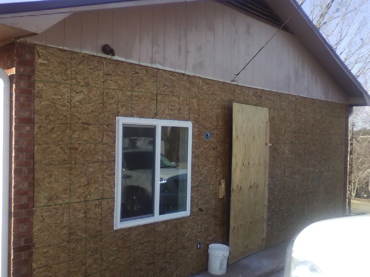 OSB sheathing on a garage addition wall before siding in New Enterprise